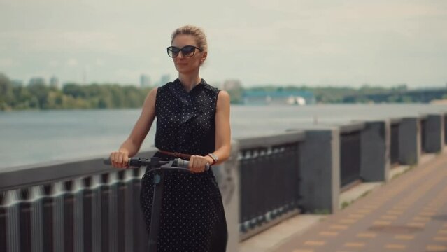 Woman traveling on electro scooter . Comfort electric transport	