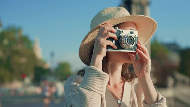 Young photographer taking a photo on the street in Paris