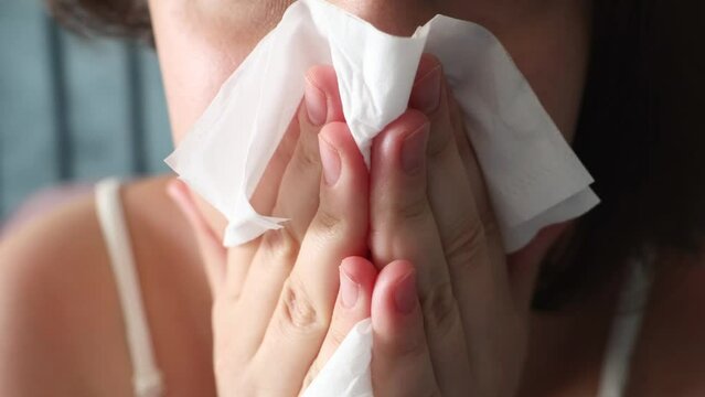 Ill upset young woman wiping nose with tissue. Health problems, cold and flue symptoms concept