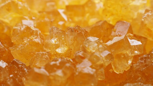 Yellow rock candy sugar crystals or Dhaga Mishri (Crystal Sweet Candy, Patika Bellam, Khadi Sakar, Kuja Misri) circle rotation close up