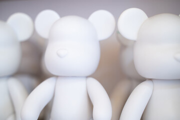 Fashionable white Bearbrick toy style on blurred background