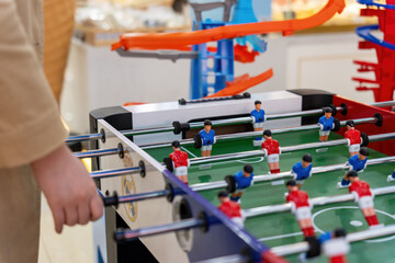 Young people playing table football game