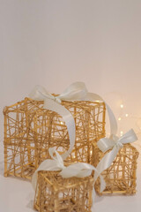 Wicker gift box with a white bow on a white fur background