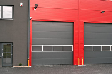 Gray Garage Doors are set against a Striking Red Wall. Industrial garage in black and red colors.