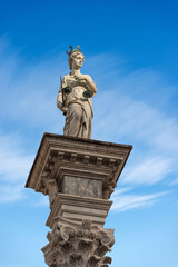 Obraz premium Marble Statue of Justice. Goddess of justice holding law scales and a sword (Themis). Freedom square (Piazza della Libertà), Udine, Friuli-Venezia Giulia, Italy, Europe.