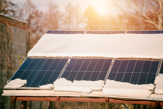 Efficient and Safe Energy Generation with Photovoltaic Technology. Photovoltaic electricity installation during the winter season. Alternative energy home production in cold weather.