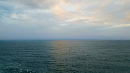 Obraz premium Panoramic cloudy marine landscape overcast weather. Aerial rays breaking clouds.