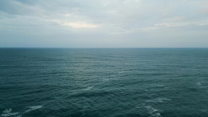 Amazing cloudy seascape beautiful ocean under gray sky. Aerial marine horizon.