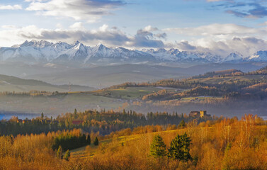 Piękna panorama ośnieżonych gór Tatry, na pierwszym planie zamek Czorsztyn.