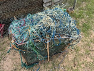 large pile of colorful tangled fishing ropes and nets 