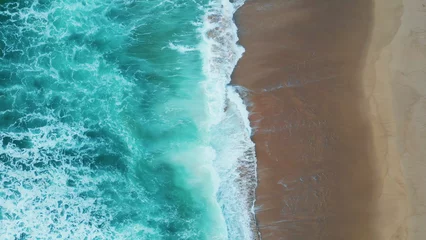 Gordijnen Drone shot turquoise sea waves washing empty tropical beach. Foamy ocean water. © stockbusters