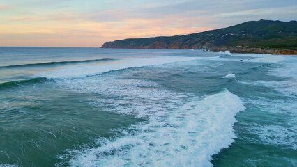 Beautiful calm ocean twilight with foamy waves on seashore. Aerial sea water