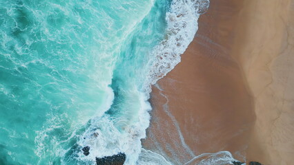 Turquoise sea waves crashing on sandy coast aerial view. Ocean washing seashore - obrazy, fototapety, plakaty