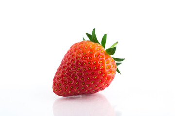 Fresh organic strawberries on a white reflective surface. Close up shot.