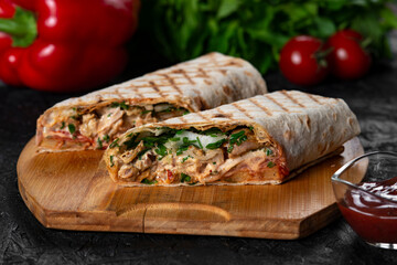 greek  meat gyros with tzatziki sauce on black background.