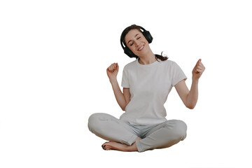 Cheerful woman in casual sitting on cozy orange sofa, listening music eyes closed using headphones...
