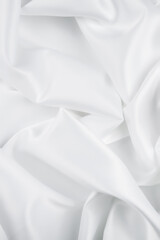White Satin Silky Cloth. Fabric Textile Drape with Crease Wavy Folds with Soft Waves. Luxurious...