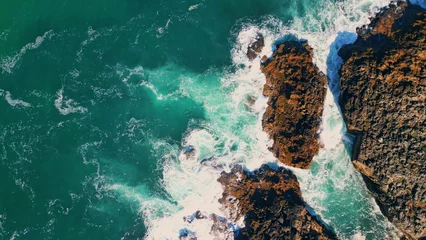 Foto op Plexiglas Stormy turquoise sea waves splashing at seashore cliffs. Aerial view seashore  © stockbusters