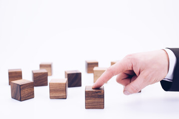 Wooden cubes and hand. The concept of people and personnel management. Manager and leader. Director and boss.