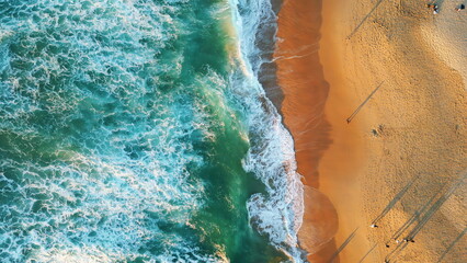 Aerial beautiful beach washed foamy ocean waves summer evening cinematic view