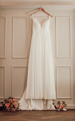 hanging wedding dress and shoes for the bride