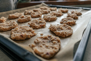unbaked keto almond flour cookies lined on some parchment paper, on a tray ready to go in the oven