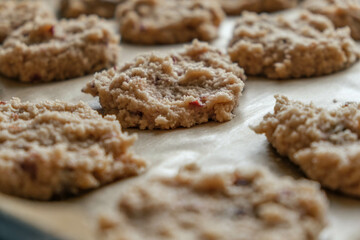 close up of fresh unbaked almond flour keto cookies lined on parchment paper ready to go in the oven