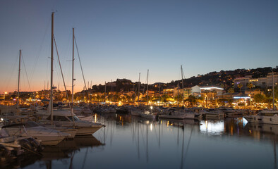 Port of Le Lavandou in the evening, France. Luxury yachts and motor boats.	
