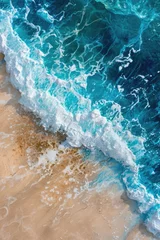 Fotobehang View from above on beach with a blue wave © BrandwayArt