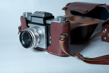 old analog camera in a leather case - on white background