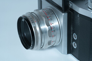 close-up of an analog lens on a camera in front of a white background