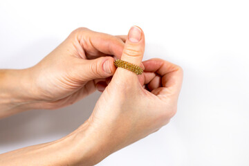A woman's hand holds a massage ring for her fingers. Massager for relaxing the muscles of the hand and fingers