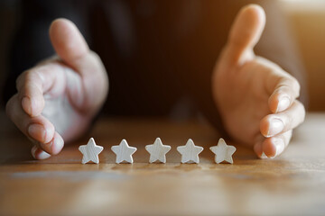 Customer Experience Concept. Man hand showing on five star excellent rating on background, copy...