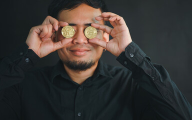 bitcoin coins in his eyes raised his finger up on the board.Conspiracy theory concept of fake and...