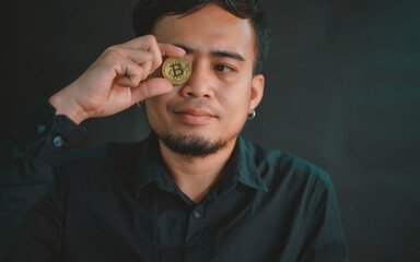 bitcoin coins in his eyes raised his finger up on the board.Conspiracy theory concept of fake and alternative facts.Cryptocurrency and mind