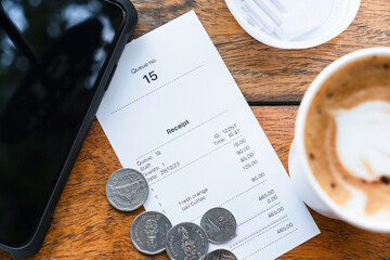 Closeup receipt of beverages and drinks with service tip and smart phone