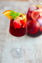 Sangria with strawberry, orange, apple and lemon on the table. Close up