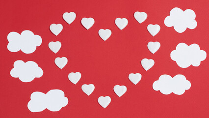 Small hearts appears one big  heart shape with copy space in center. Near white clouds. Greeting card. Valentine's day