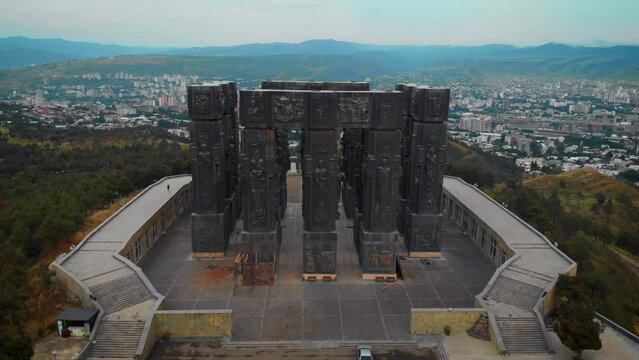 Aerial view of Monument History of Georgia, North of Tbilisi. Dramatic gray weather, overcast sky. Day time.