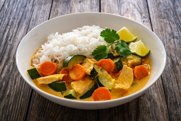 Chicken nuggets with rice and vegetables on wooden table
