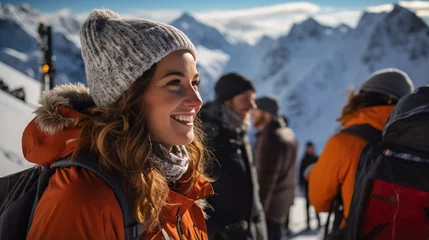 Fotobehang Young woman in winter clothes smiling in front of snow-capped mountains © Molostock