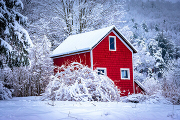 A two-story red barn stands out against the white snow from last night's heavy winter snowfall. ...