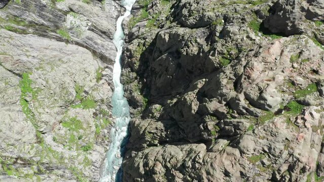 Fly through the Trift Valley over a wild river and a suspension bridge to a glacier in the Swiss Alps