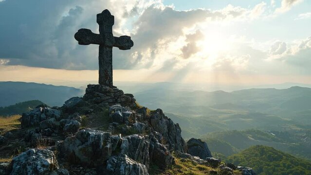 Slow motion of Christian religious symbol of cross on mountain, background under rays of the sun.