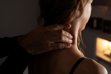 Close-up of male hands doing lymphatic drainage massage on a female neck.