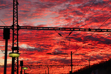 A morning red coloured sunrise with  black power lines.  Czech Republic.