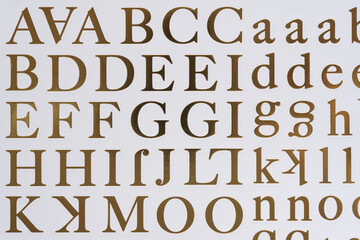 sheet of peel-off letter stickers (in metallic gold foil) on white