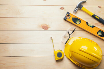 Work safety. Standard Construction site protective equipment on  top view wooden background, flat lay, copy space,safety first concepts.