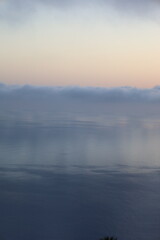 Misty morning with low clouds over the sea