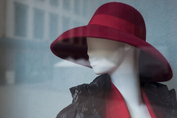 Closeup of red hat on mannequin in a fashion store showroom